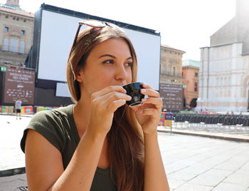 Portrait of young woman photographing
