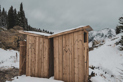 Built structure on snow covered field against sky