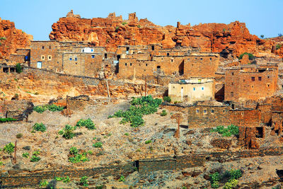 Houses on mountain against sky