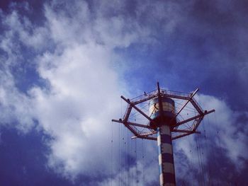 Low angle view of windmill against cloudy sky