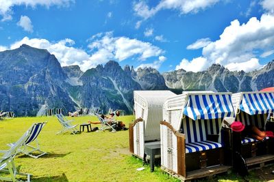 Panoramic view of chairs and mountains against sky