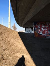 Shadow of man on road against sky