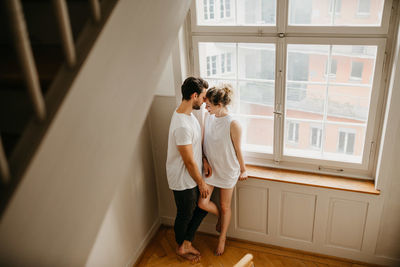 Rear view of couple standing at staircase