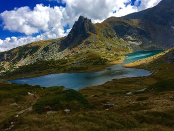 Scenic view of lake and mountains against sky