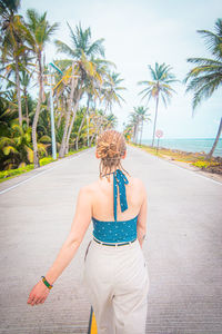 Rear view of woman walking on beach