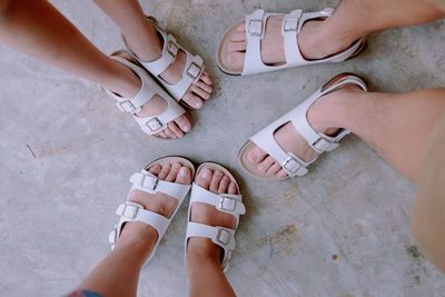 Low section of women standing on tiled floor