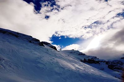 Low angle view of snowcapped mountain against sky