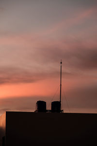 Low angle view of silhouette building against sky during sunset