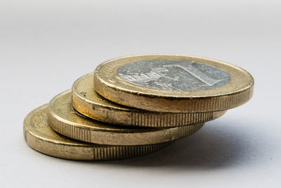 Close-up of coin stack against white background