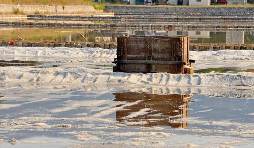 Abandoned boat on river during winter