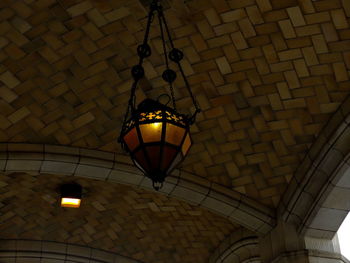 Low angle view of illuminated lantern hanging on ceiling