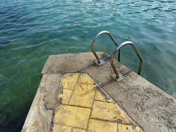 High angle view of ladder by the ocean