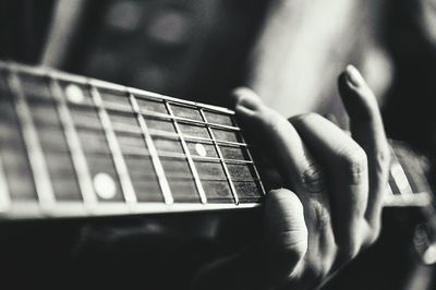 Cropped hand playing guitar