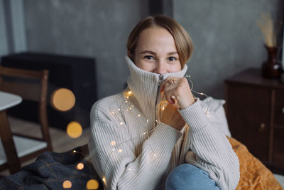 Portrait of woman sitting at home