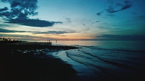 Pier on sea at sunset