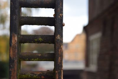 Close-up of rusty metal by building