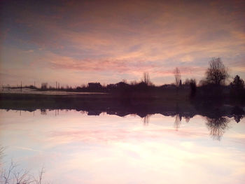 Scenic view of lake against romantic sky at sunset