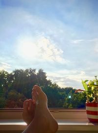 Low section of woman against sky