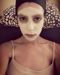 Close-up portrait of young woman at home