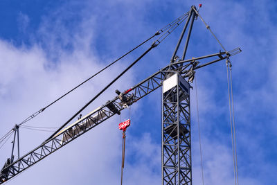 Low angle view of crane against blue sky