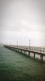 Pier over sea against sky