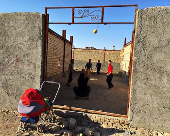 Woman standing against built structure