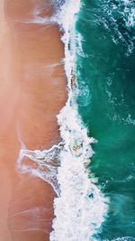 High angle view of surf on beach