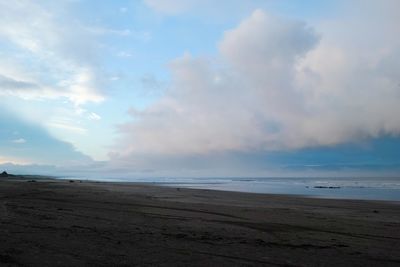 Scenic view of beach against sky during sunset