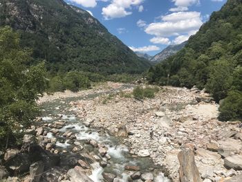 Scenic view of river amidst mountains against sky