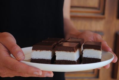 Midsection of person holding chocolate cake