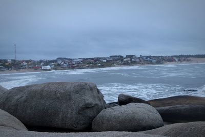 Rocks on beach against sky