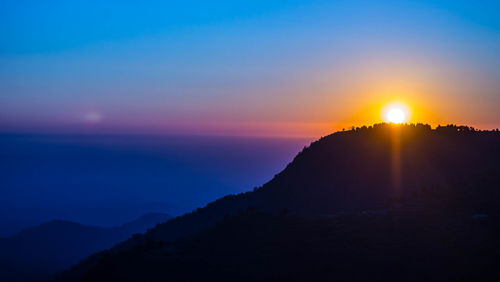 Scenic view of silhouette mountain against sky during sunset