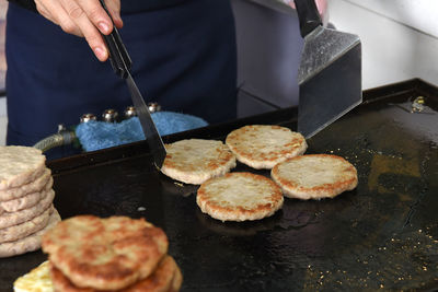 Midsection of person preparing food in kitchen