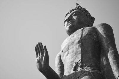 Low angle view of statue against sky