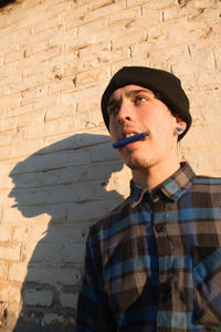 Portrait of young man smoking outdoors