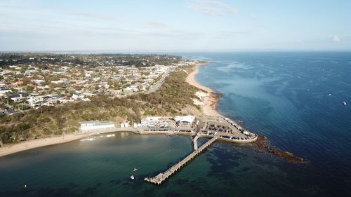 High angle view of sea and buildings against sky