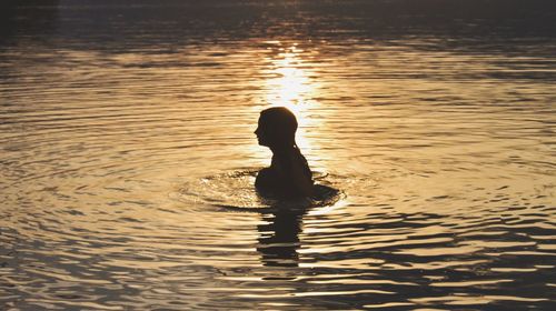 Reflection of silhouette man in water