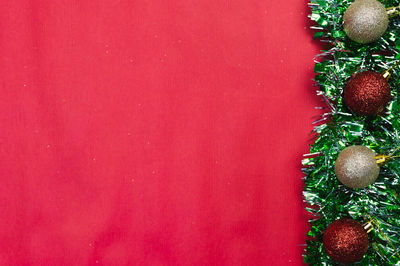 Close-up of christmas tree against red background