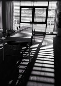 Empty chairs and table against tiled floor