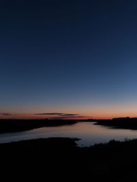 Scenic view of silhouette landscape against blue sky