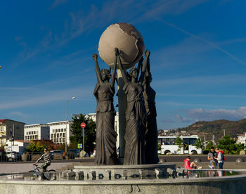 Statue against blue sky in city