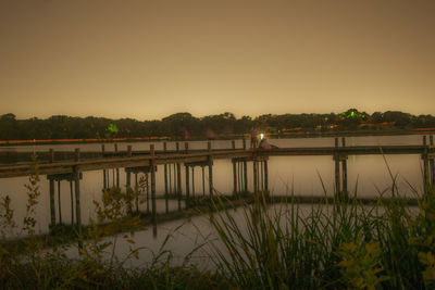 Scenic view of river against clear sky at sunset