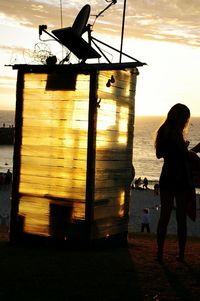 Silhouette of people in sea at sunset