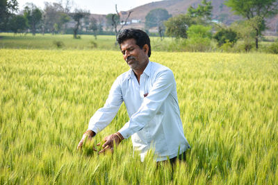 Young man standing in field