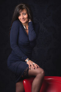 Portrait of a smiling young woman sitting outdoors