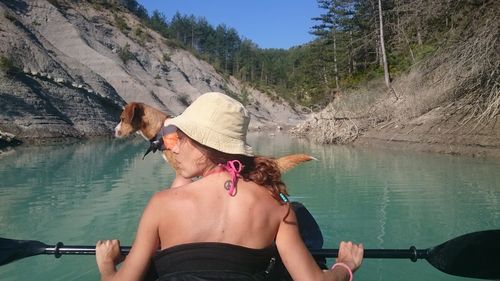 Midsection of woman in lake against mountain