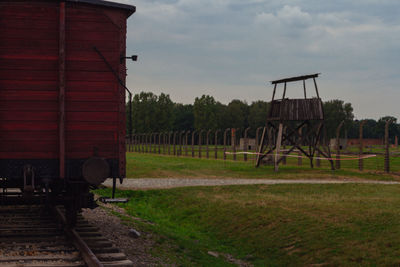 View of railroad tracks on field against sky