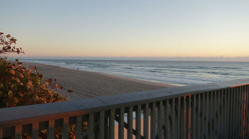 Scenic view of sea against clear sky during sunset