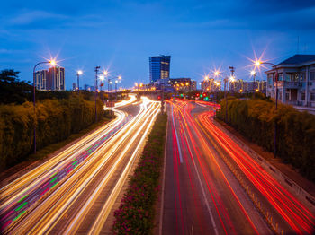 Light trails on road against sky at night