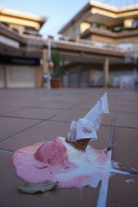 Close-up of ice cream on table against building